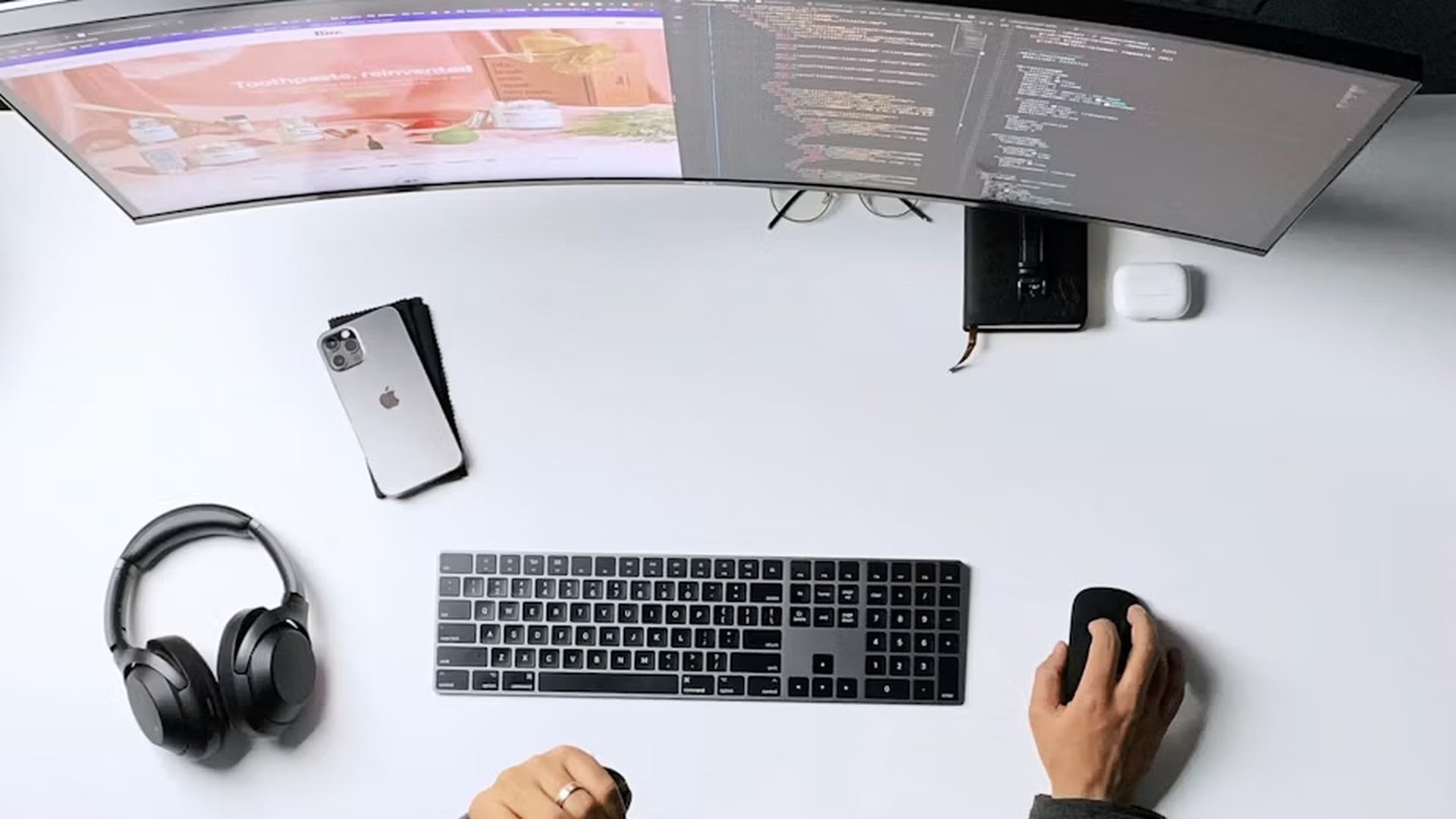 A top-down view of a desk with a phone and keyboard