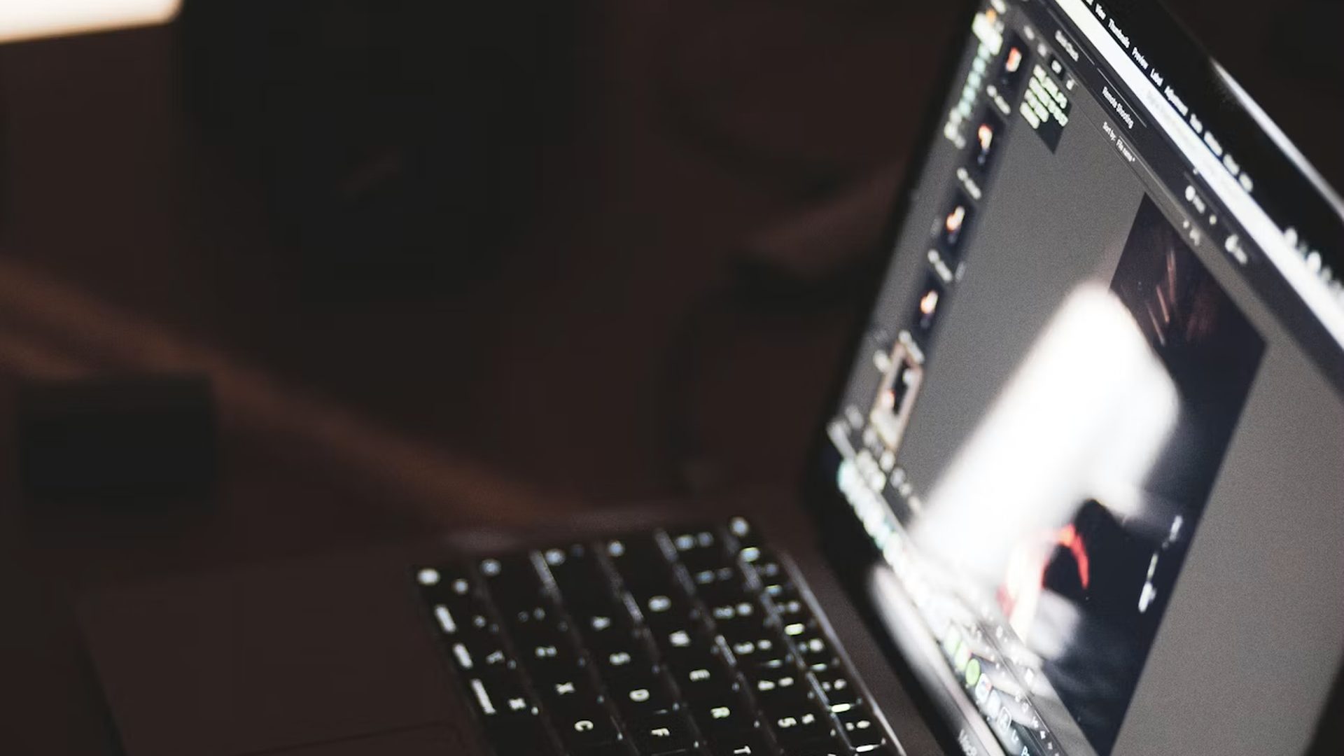 A laptop open in a dark room